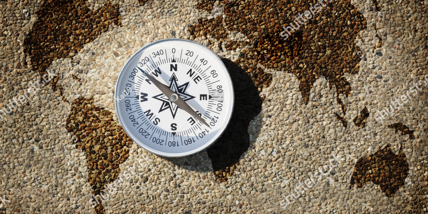 stock-photo-compass-and-world-map-on-small-gravel-stone-find-the-better-way-for-our-world-concept-708810406_copy_1500x750